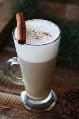 Delicious coffee latte with cinnamon on the table