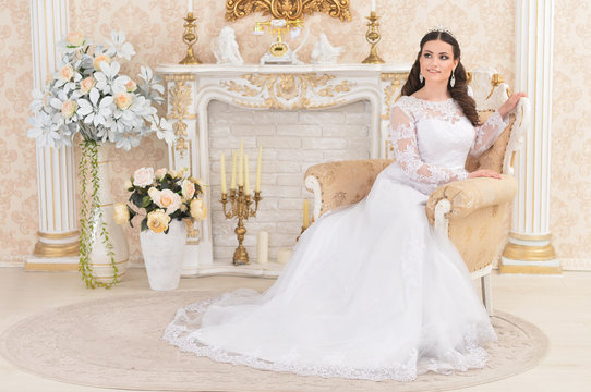 portrait of young beautiful bride in white dress posing