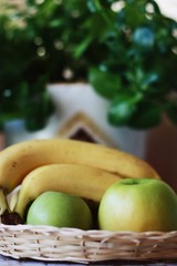 Green apples and bananas on the table