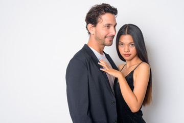 Portrait of happy multi ethnic business couple embracing together