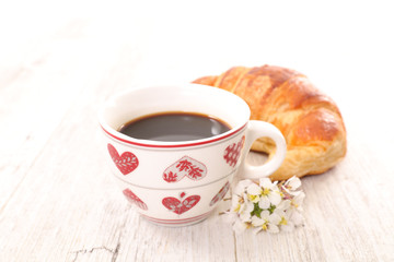 coffee cup and fresh croissant