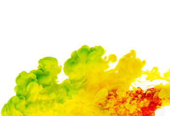 Colorful cloud of yellow, green and red ink on white background.