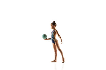 Little flexible girl isolated on white studio background. Little female model as a rhythmic...
