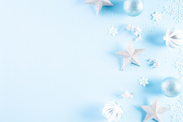 Christmas background concept. Top view of Christmas ball with snowflakes on light blue pastel background.