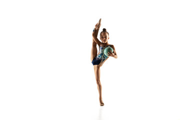 Little flexible girl isolated on white studio background. Little female model as a rhythmic...
