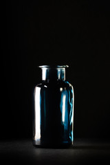  glass bottle against a dark background