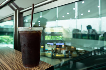 Ice coffee americano in a glass on wood table