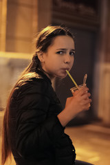 Fototapeta premium A beautiful girl drinking fresh juice
