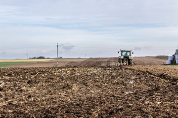 Wheel tractor with multi-plow. Plowing the land in late autumn. Podlasie, Poland.
