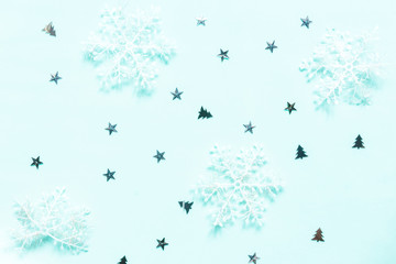 Christmas flat lay background. Gold glitter and festive decor on neo mint background. Christmas festive background.