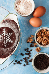 Brownie for Christmas and winter holidays. Homemade chocolate fudge brownie with ingredients and blue background. Merry Christmas.