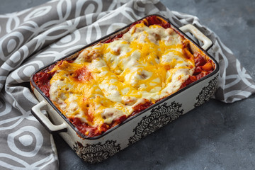 Spinach and ricotta stuffed cannelloni baked  in tomato sauce.