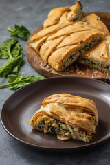 Homemade savory braided puff pastry with spinach and ricotta filling. 