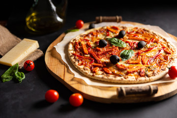 chicken tomato pepper pizza with olives and basil; horizontal
