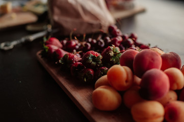 fresh strawberries and peaches on the kitchen table