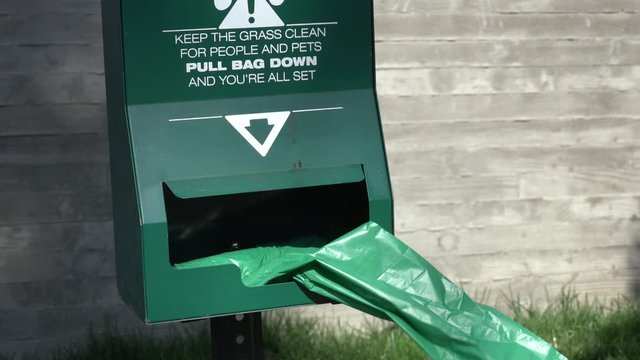 dog poop bag flap in wind isolated brick background 