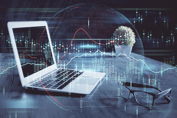 Double exposure of chart and financial info and work space with computer background. Concept of international online trading.