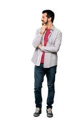 Full-length shot of Handsome man with beard looking to the side over isolated white background