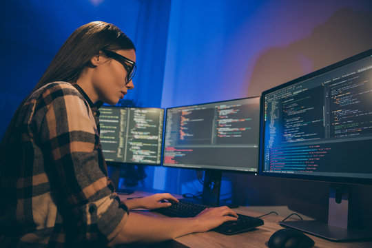 Photo of focused concentrated serious programmer looking through code of artificial intelligence to be debugged