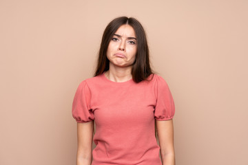Obraz premium Young woman over isolated background sad