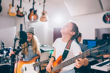Fotobehang kids rock band in music studio © cherryandbees