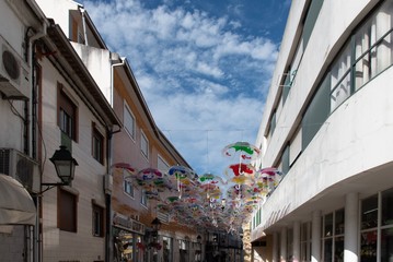 Fototapeta na wymiar Colorful umbrellas hung over the streets of Agueda, Portugal.