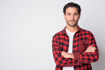 Portrait of handsome Hispanic hipster man with arms crossed