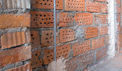 Repair. Brick wall with plaster beacon guides