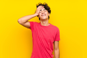 Fototapeta na wymiar Young man over isolated yellow wall laughing