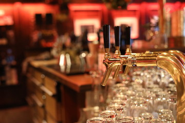Close up of golden spigot in bar