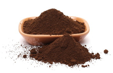 Instant espresso powdered coffee in clay pot, isolated on white background