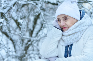 Close up portrait of upset beautiful senior woman