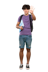 A full-length shot of a Young student man counting five with fingers over isolated white background