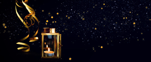 Golden lantern on black background