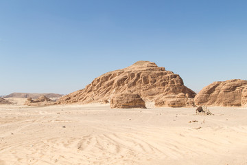 Fototapeta na wymiar Desert, red mountains, rocks and blue sky. Egypt, the Sinai Peninsula.