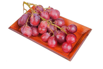 Fresh bunch of grapes on plate isolated on white background