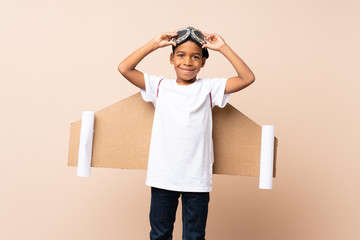 African American boy with aviator hat and with wings over isolated background