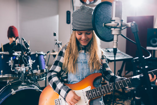 Kids Playing Instruments In Music Studio