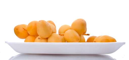 Yellow raw date palm isolated on white background.