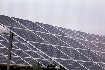A power plant using renewable solar energy with the sun. Solar cells or photovoltaic cells in solar power plant station turn up skyward absorb the sunlight from the sun. closeup of photo.