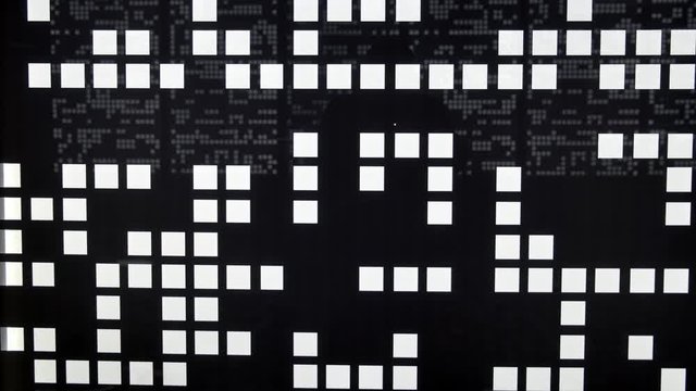 Silhouette of man passes on abstract background. White squares on black wall in chaotic manner.