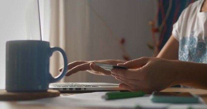 Portrait of a woman buying online or booking hotel with a laptop and credit card in vacations. E-commerce concept