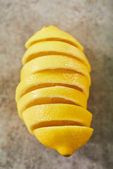 Naklejka na ściany i meble top view of sliced and ripe lemon on marble surface
