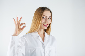 Young doctor woman in medical gown with tablets in her hand.