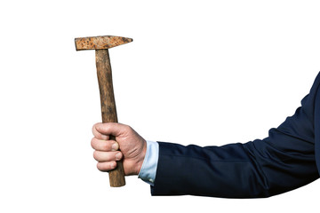 Hand of a strong business man wearing suit holding an old rusty hammer isolated on the white...