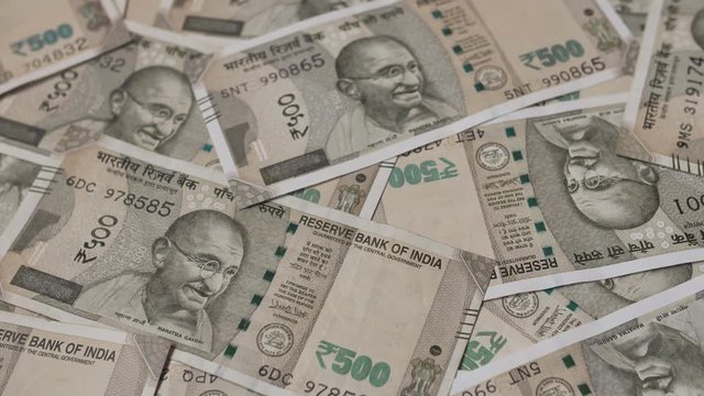 Indian money with 500 rupee bills in unfolded form.