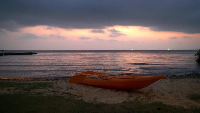 canue on tropical beach with sunset