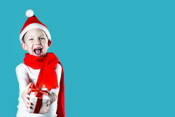 little cheerful Santa gives a gift on mint background