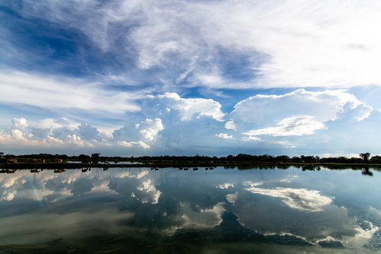 The clouds reflect the water surface during the rainy season in Thailand. © Woraphon