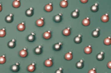 Christmas small balls to decorate the Christmas tree. Green background.